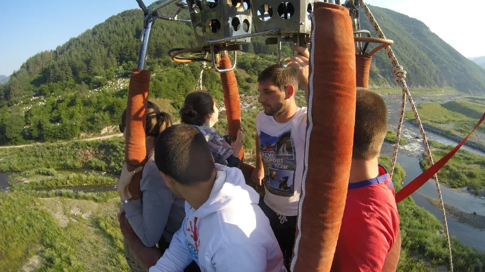 Sparkling‑wine toast during hot air balloon flight – Sofia North