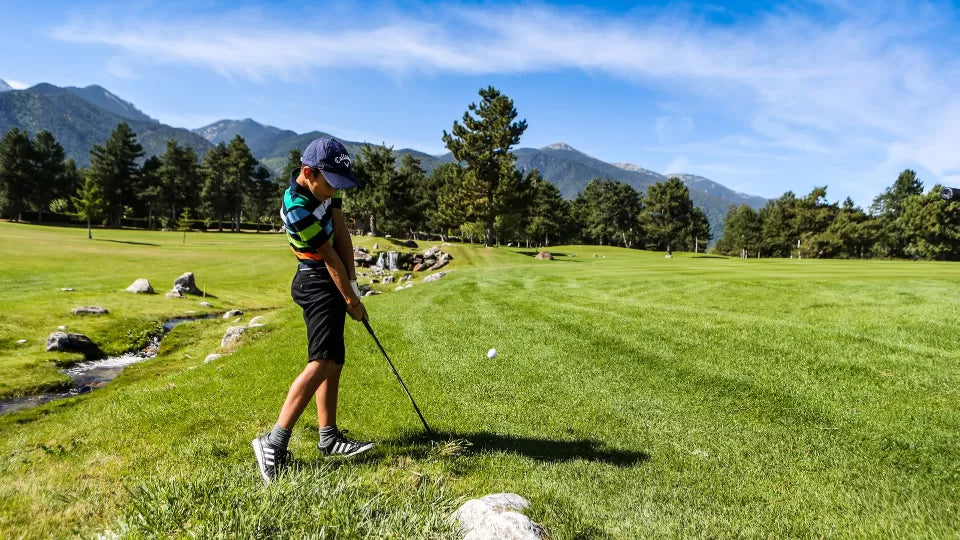 Kids golf camp in Bansko – children practicing swings on the range