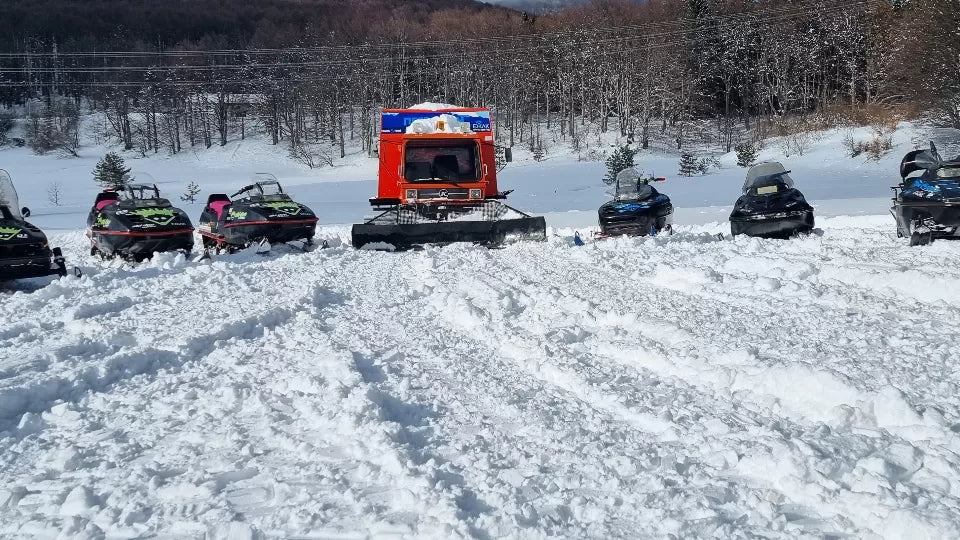 Guided snowmobile group on open plateau by Petrohan