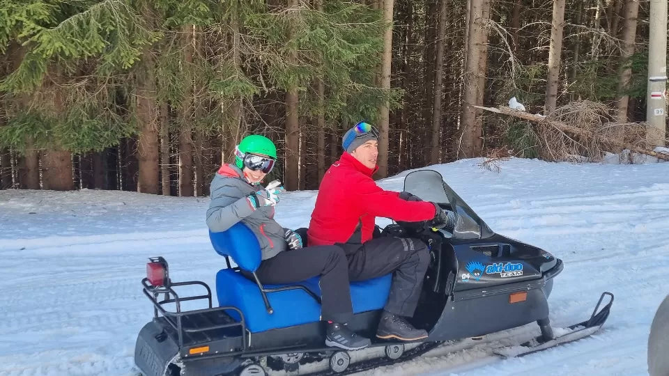 Tea break during a Petrohan snowmobile ride below Mount Kom