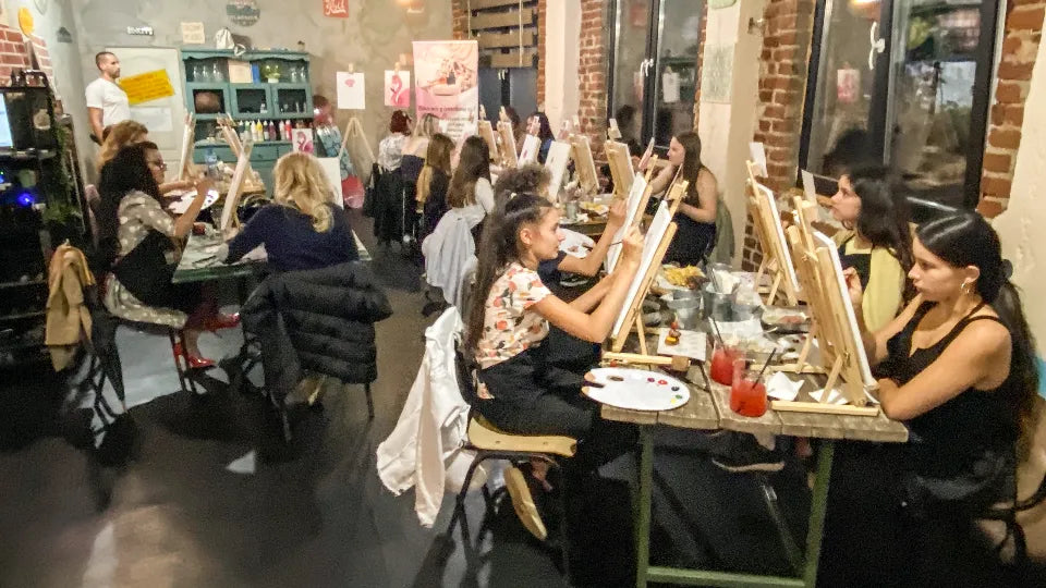 Paint and sip setup in Sofia with canvases and paints on tables