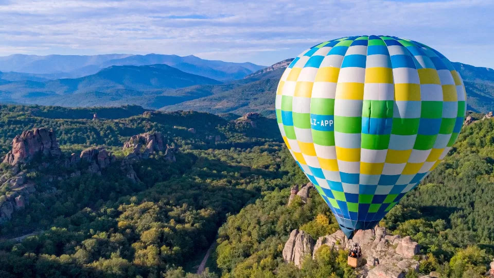 Hot air balloon rising to ~80 m near the Kaleto Fortress in Belogradchik