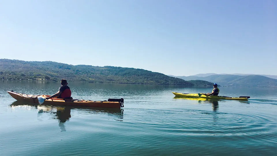 Touring double kayak with safety gear on the shore