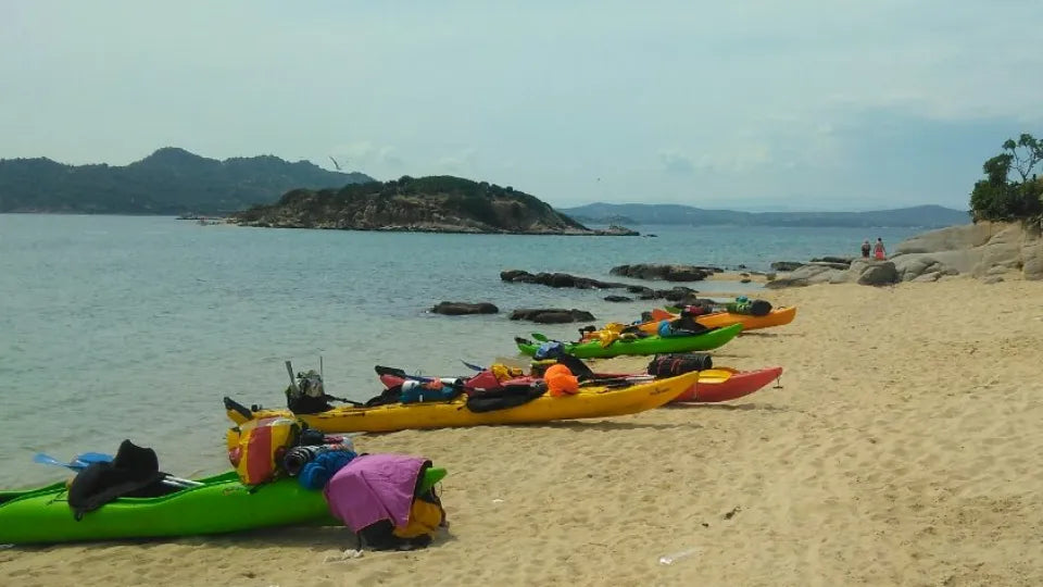 Group kayaking on calm waters with scenic reservoir views