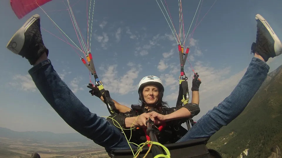 Pilot and passenger soaring over Sopot on a tandem paraglider