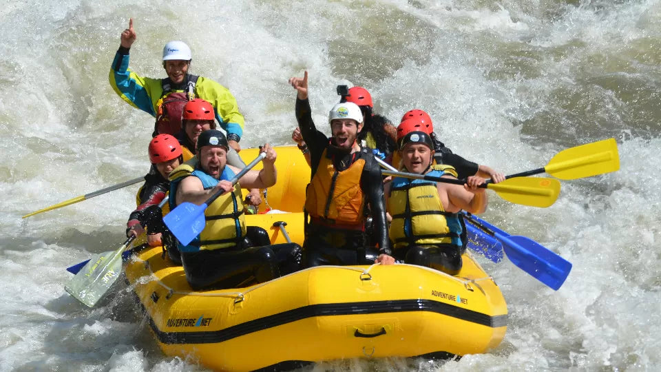 Guide leading a raft through rapids on the Struma River