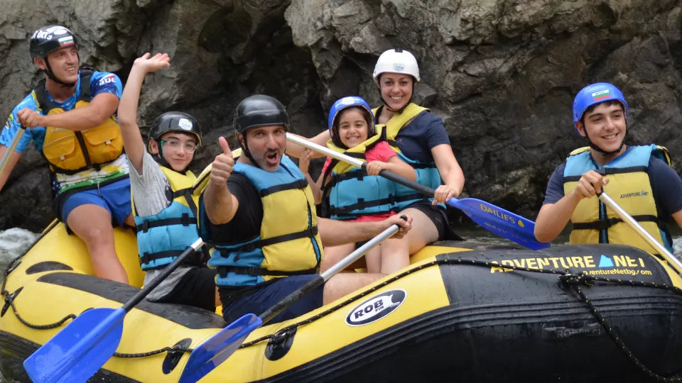 Guide leading a family rafting boat on the Struma near Kresna