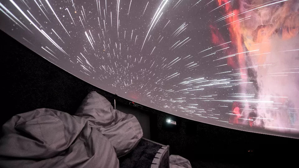 Couple watching astronomy films on the dome during a private planetarium date in Sofia