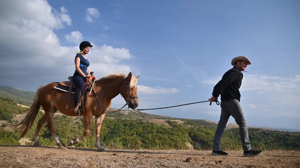 Instructor guiding a beginner rider near Sandanski