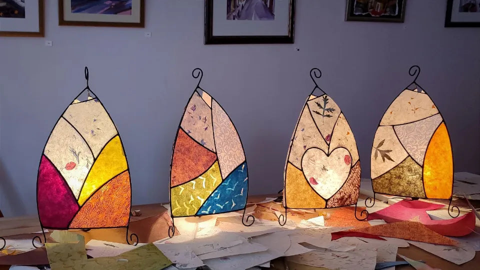 Group creating custom lamps in a relaxed studio with music and wine