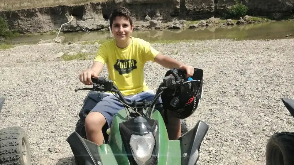 Child riding a 125cc kids ATV on an off-road trail, Plovdiv area