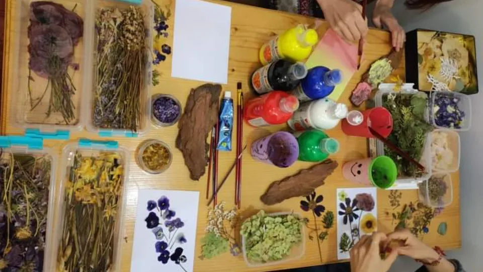 Arranging pressed flowers during a workshop in central Sofia