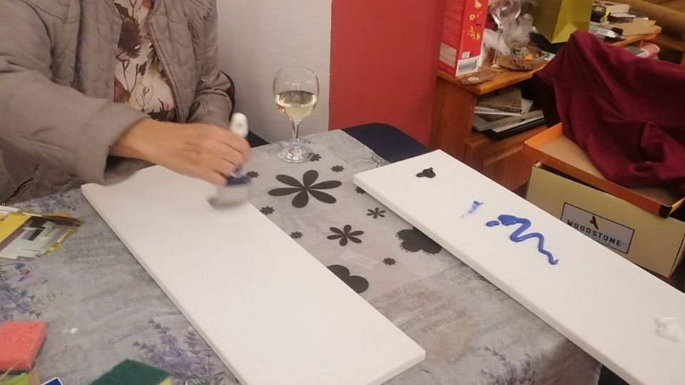 Acrylic paints, brushes and a glass of wine at a Sofia art class