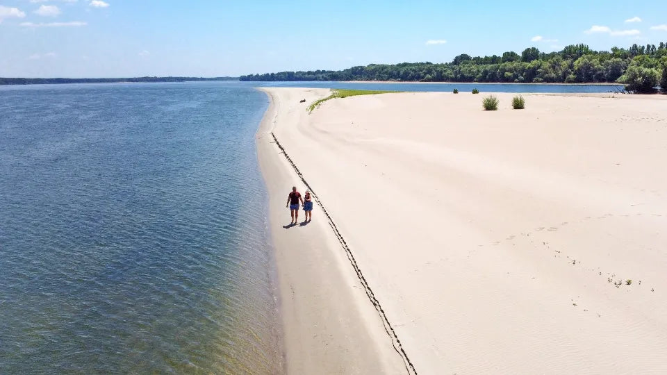 Campfire and tents on a wild sandbar near Vardim Island