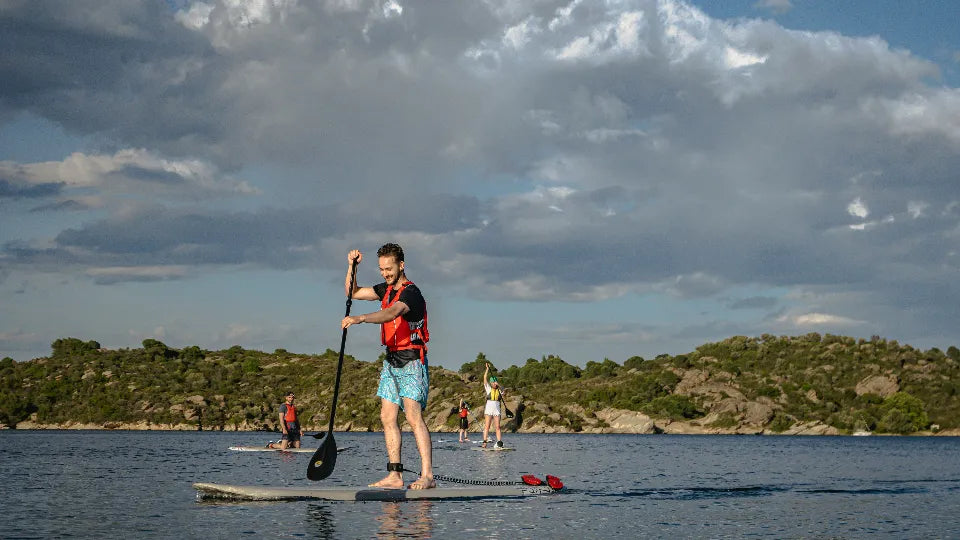First-time paddler on a SUP board in Diaporos’ turquoise lagoons