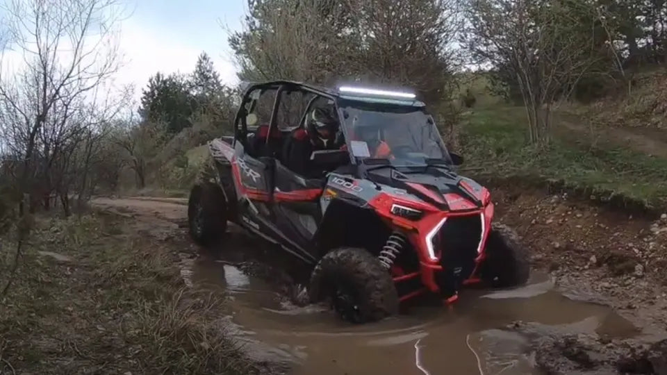UTV Polaris RZR crossing the Iskar river bed in Lozen Mountain