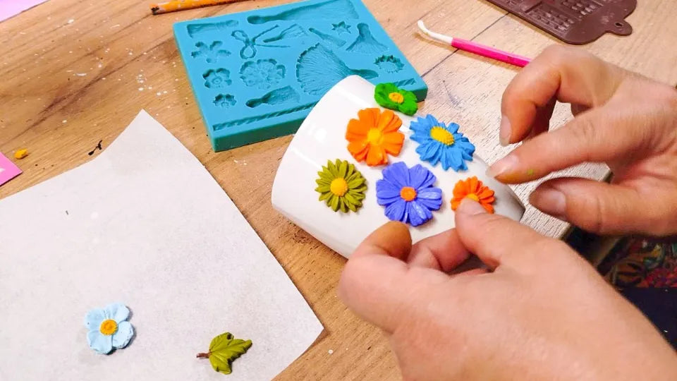 Guests decorating white mugs with polymer clay — Sofia