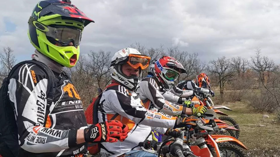 KTM enduro motorcycle descending a mountain dirt track with panoramic views near Bansko