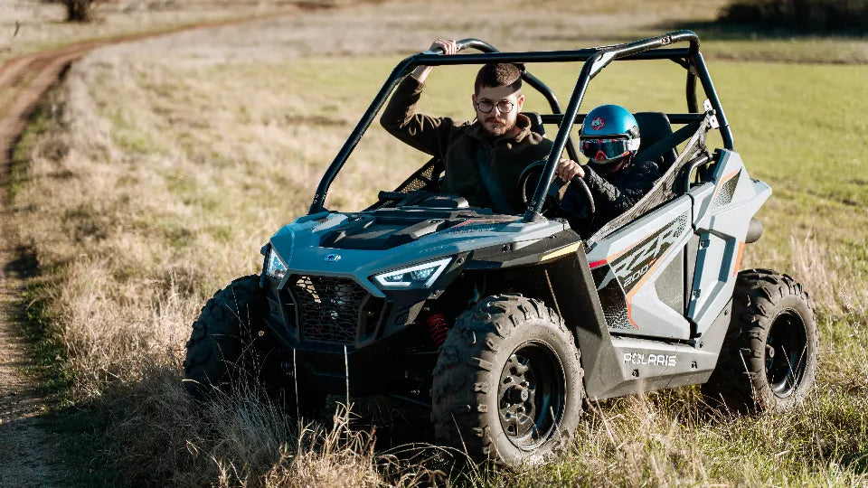 Instructor guiding a child during an off-road buggy lesson