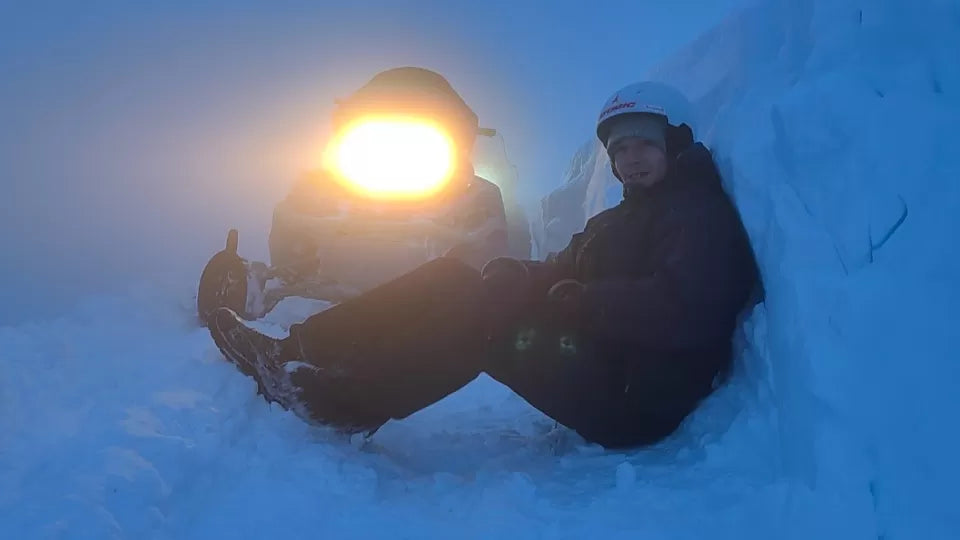Snowmobile headlamps at night on the Petrohan pass