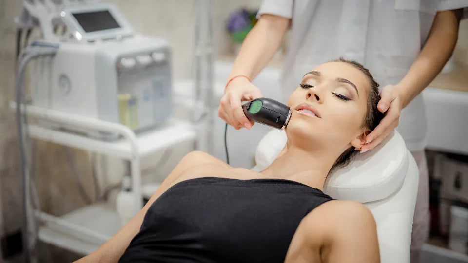 Esthetician performing facial cleansing treatment in a Burgas studio