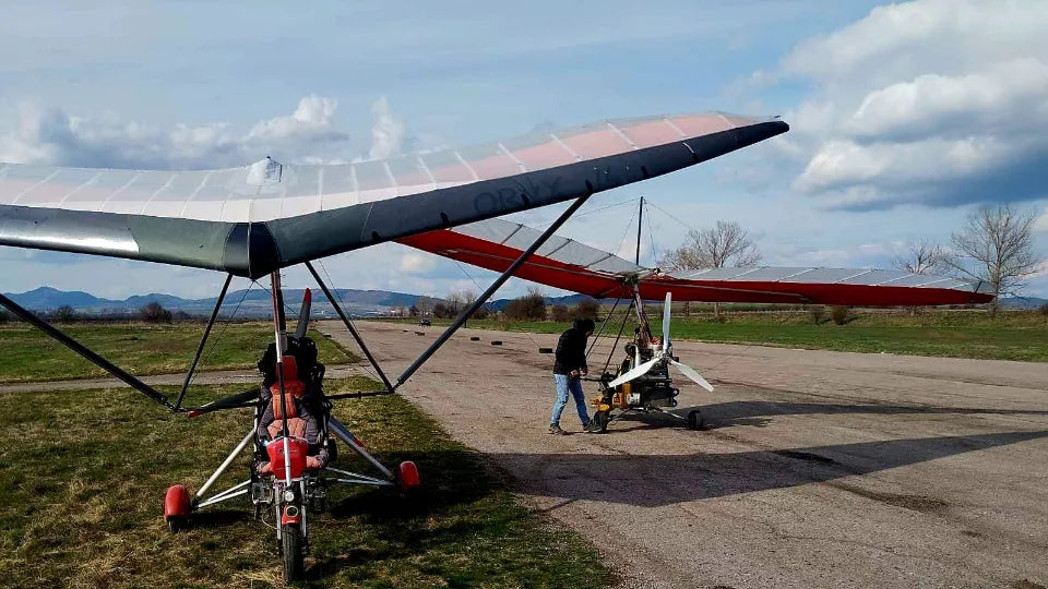 Passenger and pilot on a powered hang glider during flight near Sofia