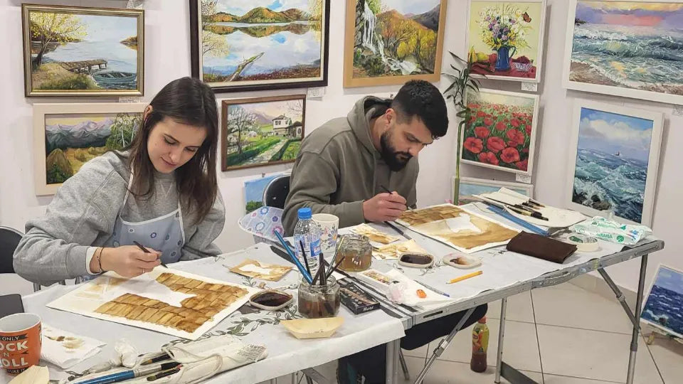 Participant painting with coffee in a watercolor style