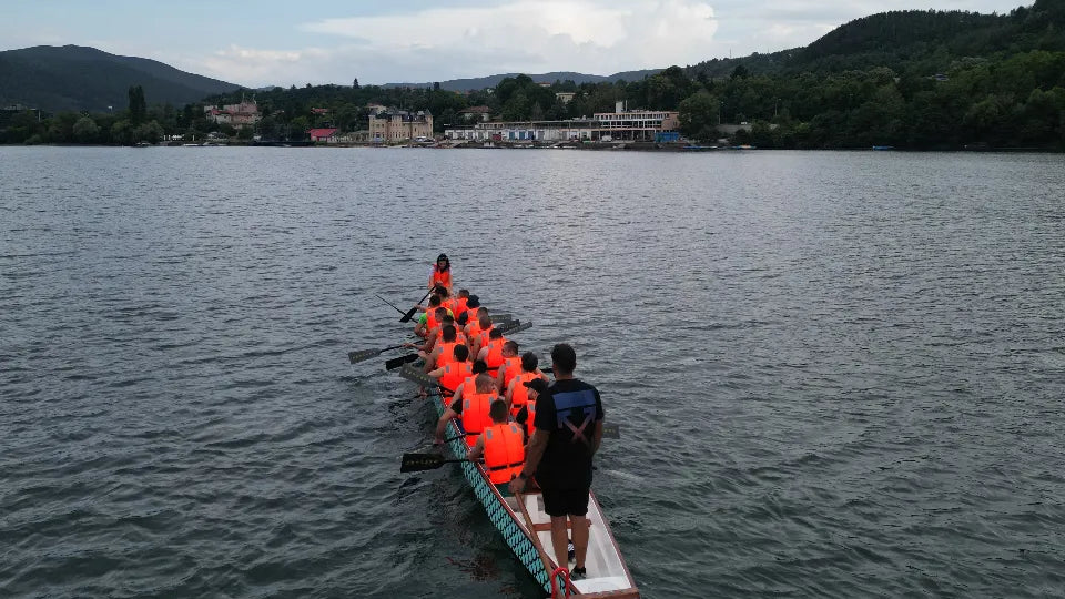 Paddling a dragon boat on the calm waters of Pancharevo Lake