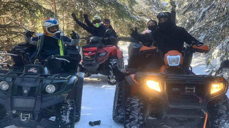 Two riders on an ATV on a forest trail near Devin