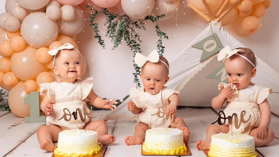 Playful cake smash portrait with frosting on cheeks in Sofia