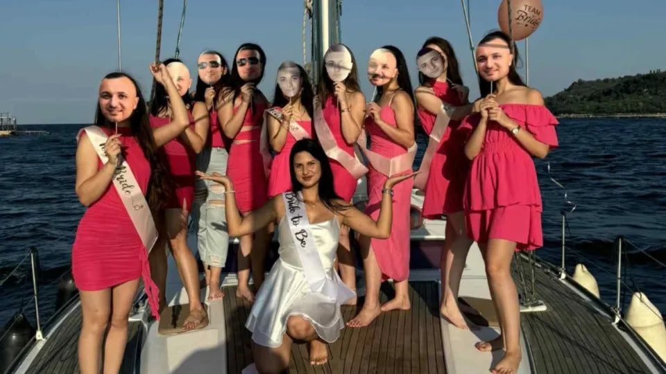 Bachelorette yacht party in Varna Bay with friends toasting on board
