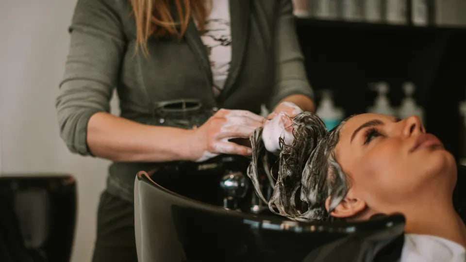 Hairdresser styling a woman’s hair with a blow-dryer in Mladost, Sofia