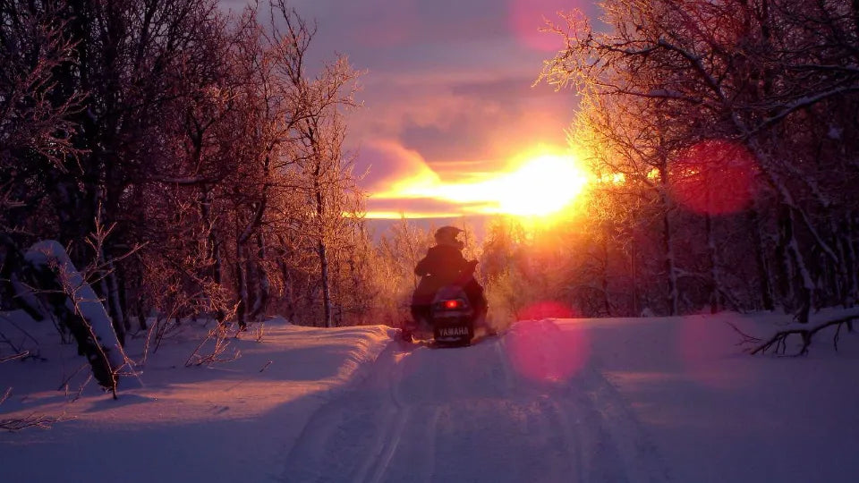 Night snowmobile ride on Vitosha with headlights on fresh snow