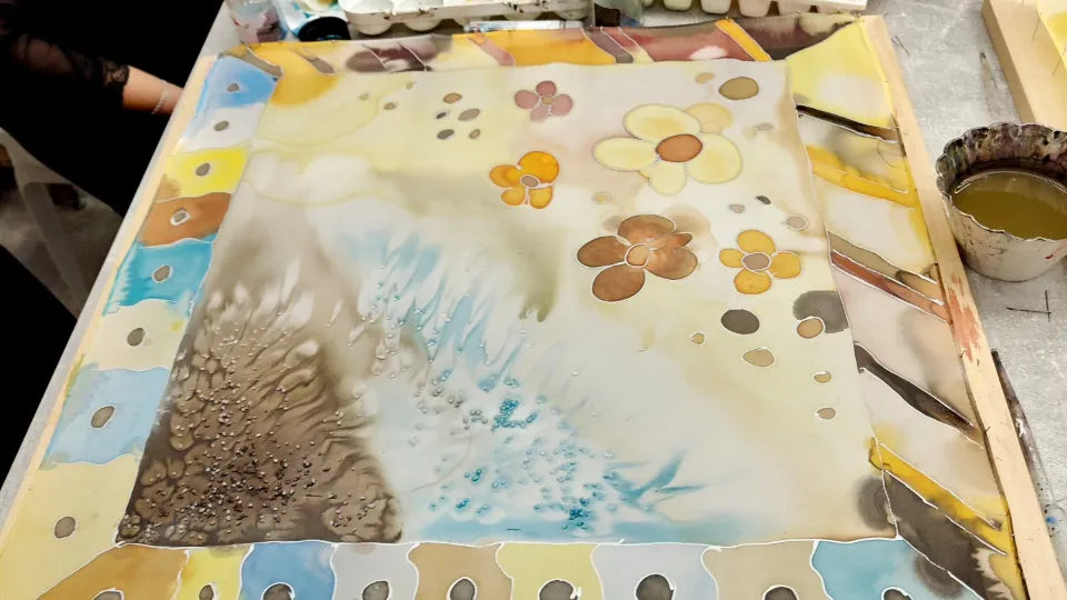 Participant painting a silk scarf in Veliko Tarnovo studio