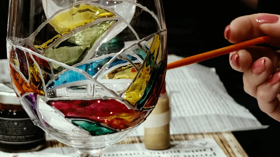 Participant painting a wine glass with glass paints in Veliko Tarnovo
