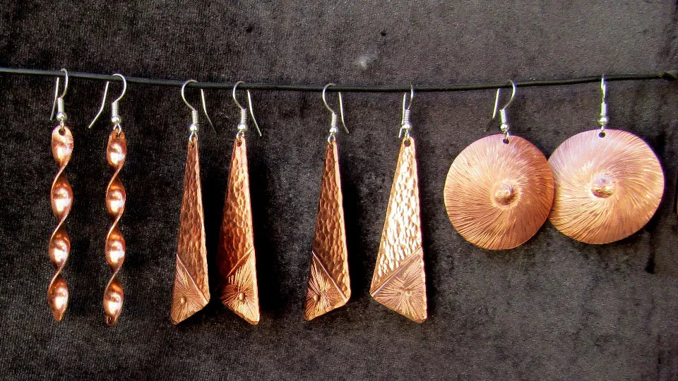 Coppersmithing tools and copper sheet during a workshop
