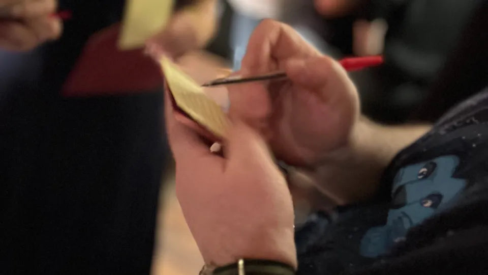 Teams discuss theories during a live mystery game in Varna