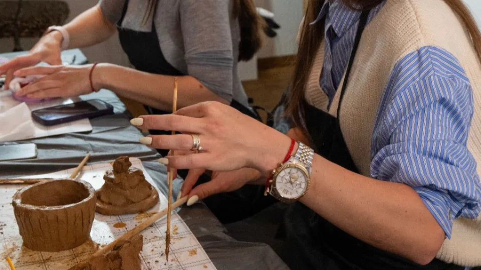Participants creating pottery with a glass of wine in a studio, Burgas